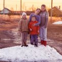 children play on the farm on a snowdrift